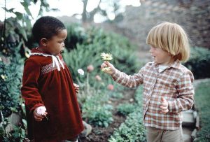 Poignant courtship in Cape Town. Inter-racial marriage is in fact illegal in South Africa, although resistance to the law is growing. Children however don't know about racial discrimination. 1/Jan/1982. Cape Town, South Africa. UN Photo/x. www.unmultimedia.org/photo/